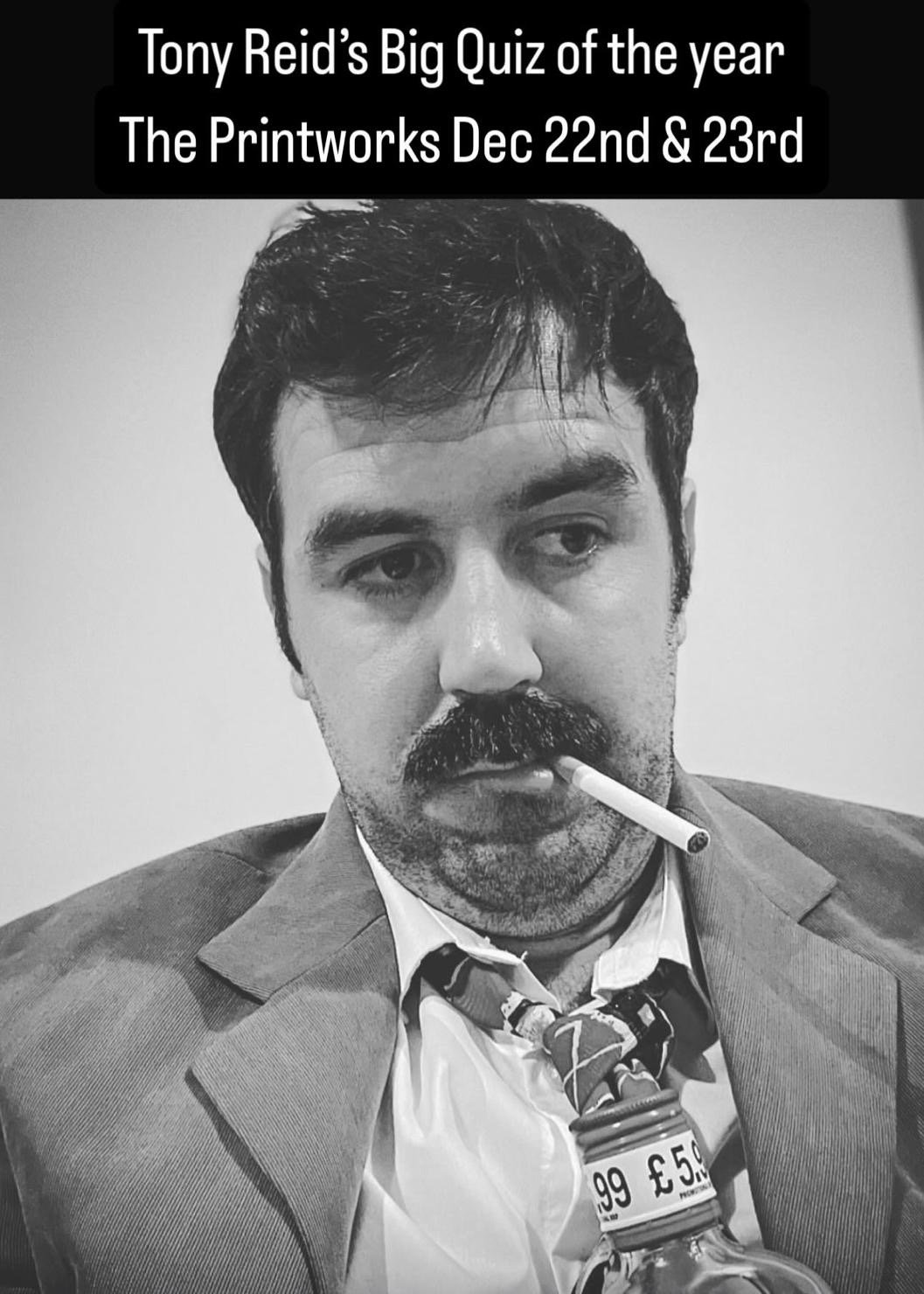 Tony Reid, quizmaster, in a corduroy jacket with a cigarette, for the Big Quiz of the Year at The Printworks